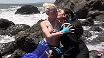 One Girl, Dressed As A Mermaid, Was Engaging In A Romantic Act Of Kissing With Another Female, Who Had Brown Hair And Identified As A Lesbian, Near The Water